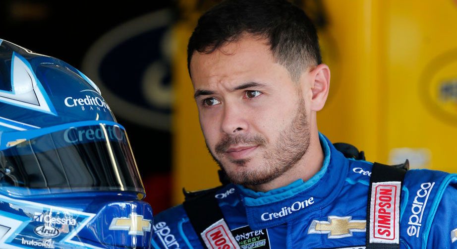 Kyle Larson in Kansas garage with Credit One firesuit