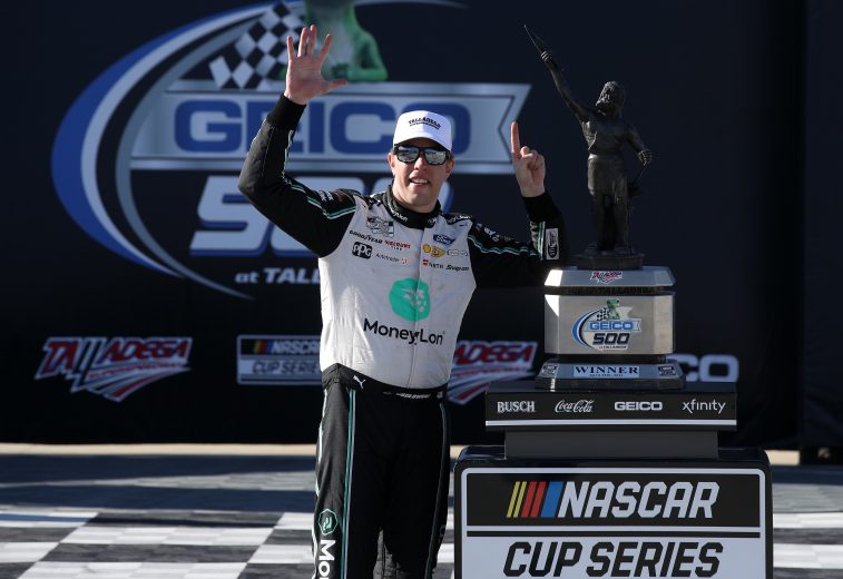 Brad Keselowski holds up six fingers in Victory Lane at Talladega after winning his sixth race at the track