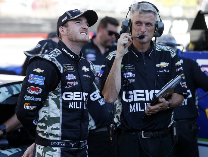 BRISTOL, TENNESSEE - AUGUST 16: Ty Dillon, driver of the #13 GEICO Military Chevrolet, and crew chief Matt Borland stand on the grid during qualifying for the Monster Energy NASCAR Cup Series Bass Pro Shops NRA Night Race at Bristol Motor Speedway on August 16, 2019 in Bristol, Tennessee. (Photo by Brian Lawdermilk/Getty Images) | Getty Images