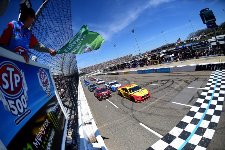 MARTINSVILLE, VA - MARCH 24: Joey Logano, driver of the #22 Shell Pennzoil Ford, and Aric Almirola, driver of the #10 SHAZAMSmithfield Ford, lead the field to the green flag to start the Monster Energy NASCAR Cup Series STP 500 at Martinsville Speedway on March 24, 2019 in Martinsville, Virginia. (Photo by Jared C. Tilton/Getty Images) | Getty Images