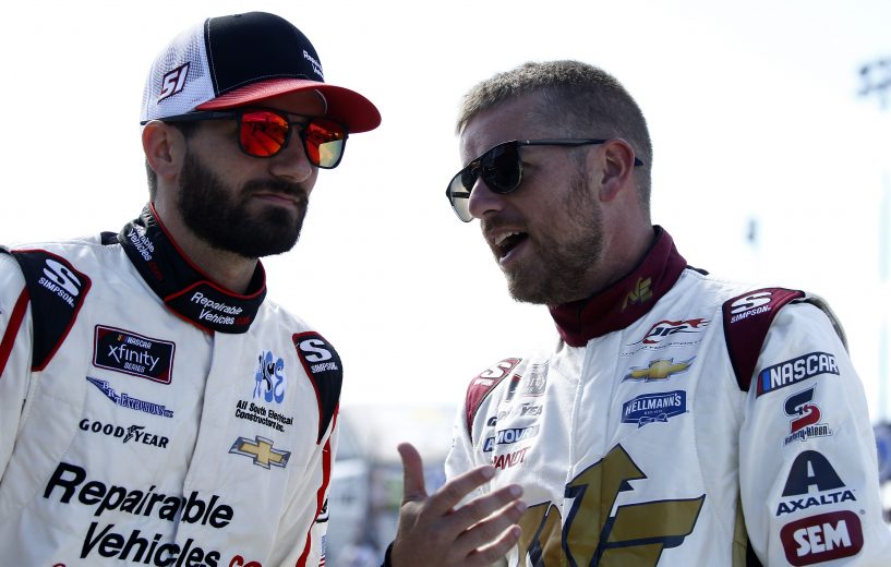 DOVER, DELAWARE - OCTOBER 05: Jeremy Clements, driver of the #51 RepairableVehicles.com Chevrolet, talks with Justin Allgaier, driver of the #7 Northeastern Supply Chevrolet, on the grid during qualifying for the NASCAR Xfinity Series Use Your Melon Drive Sober 200 at Dover International Speedway on October 05, 2019 in Dover, Delaware. (Photo by Jeff Zelevansky/Getty Images)