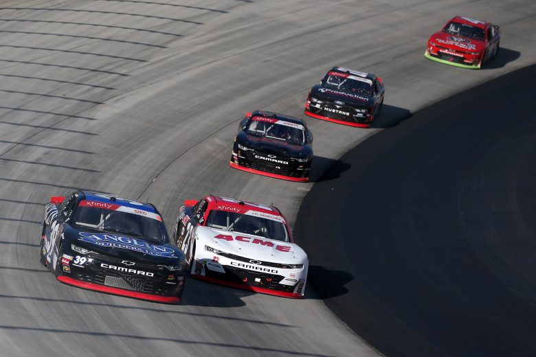 DOVER, DELAWARE - OCTOBER 05: Ryan Sieg, driver of the #39 Anglin Builders Inc Chevrolet, and John Hunter Nemechek, driver of the #23 ACME Chevrolet, lead a pack of cars during the NASCAR Xfinity Series Use Your Melon Drive Sober 200 at Dover International Speedway on October 05, 2019 in Dover, Delaware. (Photo by Matt Sullivan/Getty Images) | Getty Images