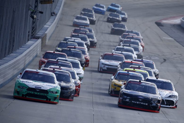 DOVER, DELAWARE - OCTOBER 05: Austin Cindric, driver of the #22 MoneyLion Ford, and Cole Custer, driver of the #00 Production Alliance Group Ford, take the green flag to start the NASCAR Xfinity Series Use Your Melon Drive Sober 200 at Dover International Speedway on October 05, 2019 in Dover, Delaware. (Photo by Jeff Zelevansky/Getty Images)