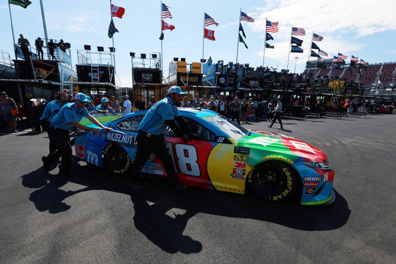 TALLADEGA, ALABAMA - OCTOBER 11: Crew members push the #18 M&M's Hazelnut Toyota, driven by Kyle Busch(not pictured), through the garage area during practice for the Monster Energy NASCAR Cup Series 1000Bulbs.com 500 at Talladega Superspeedway on October 11, 2019 in Talladega, Alabama. (Photo by Sean Gardner/Getty Images) | Getty Images