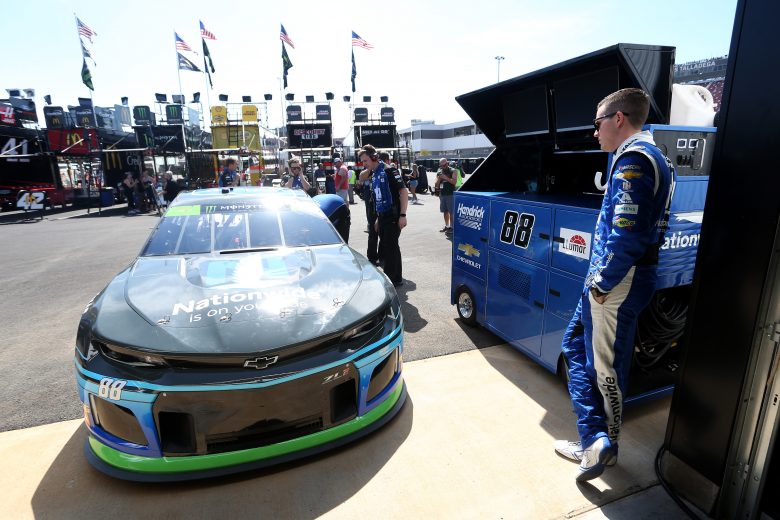 TALLADEGA, ALABAMA - OCTOBER 11: Alex Bowman, driver of the #88 Nationwide/Amazon Echo Auto Chevrolet, stands in the garage area during practice for the Monster Energy NASCAR Cup Series 1000Bulbs.com 500 at Talladega Superspeedway on October 11, 2019 in Talladega, Alabama. (Photo by Brian Lawdermilk/Getty Images) | Getty Images