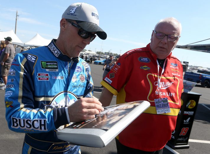 TALLADEGA, ALABAMA - OCTOBER 11: Kevin Harvick, driver of the #4 Busch Light Ford, signs an autograph for a fan during practice for the Monster Energy NASCAR Cup Series 1000Bulbs.com 500 at Talladega Superspeedway on October 11, 2019 in Talladega, Alabama. (Photo by Brian Lawdermilk/Getty Images) | Getty Images