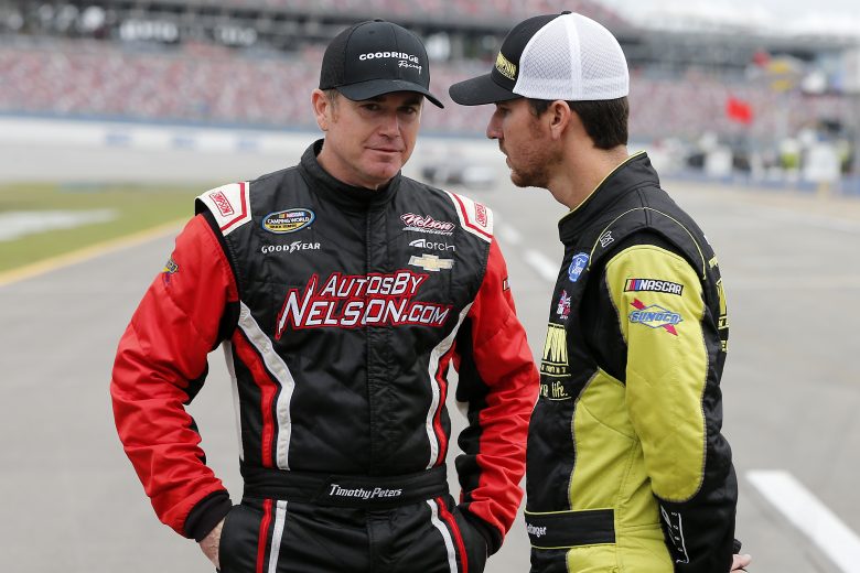 TALLADEGA, ALABAMA - OCTOBER 12: Timothy Peters, driver of the #87 Friends of Jaclyn Foundation Chevrolet, speaks with Grant Enfinger, driver of the #98 Champion Power Equipment Ford, on the grid during qualifying for the NASCAR Gander Outdoor Truck Series Sugarlands Shine 250 at Talladega Superspeedway on October 12, 2019 in Talladega, Alabama. (Photo by Brian Lawdermilk/Getty Images) | Getty Images