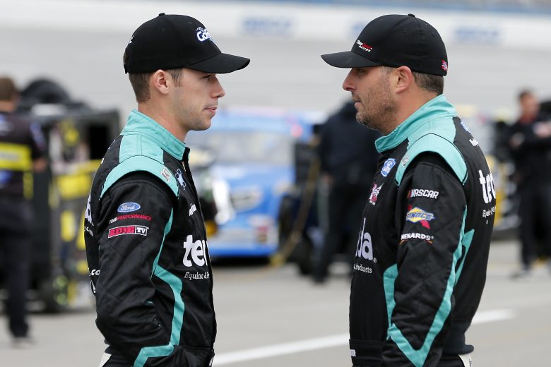 TALLADEGA, ALABAMA - OCTOBER 12: Ben Rhodes(L), driver of the #99 Havoline/Dish Fish Ford, and Johnny Sauter, driver of the #13 Tenda Heal Ford, speak on the grid during qualifying for the NASCAR Gander Outdoor Truck Series Sugarlands Shine 250 at Talladega Superspeedway on October 12, 2019 in Talladega, Alabama. (Photo by Brian Lawdermilk/Getty Images) | Getty Images