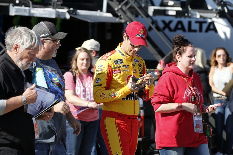 KANSAS CITY, KANSAS - OCTOBER 18: Joey Logano, driver of the #22 Shell Pennzoil Ford, signs autographs for fans in the garage area during practice for the Monster Energy NASCAR Cup Series Hollywood Casino 400 at Kansas Speedway on October 18, 2019 in Kansas City, Kansas. (Photo by Brian Lawdermilk/Getty Images) | Getty Images
