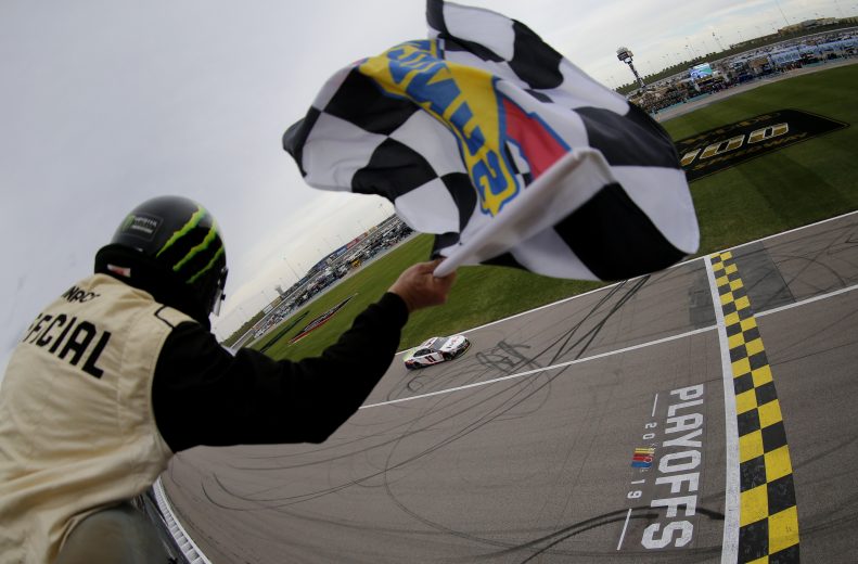 KANSAS CITY, KANSAS - OCTOBER 20: Denny Hamlin, driver of the #11 FedEx Office Toyota, takes the checkered flag to win the Monster Energy NASCAR Cup Series Hollywood Casino 400 at Kansas Speedway on October 20, 2019 in Kansas City, Kansas. (Photo by Jonathan Ferrey/Getty Images) | Getty Images