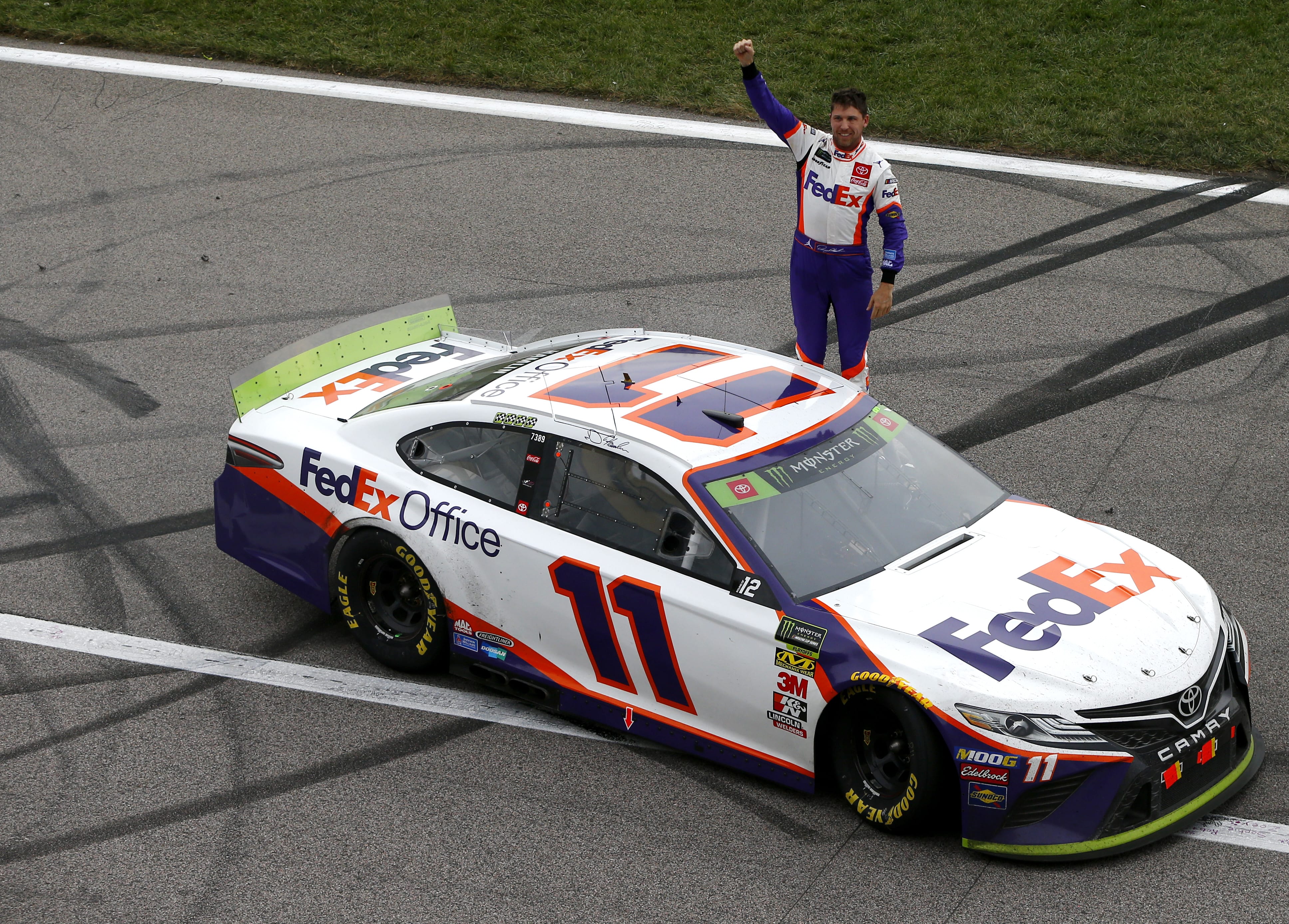 KANSAS CITY, KANSAS - OCTOBER 20: Denny Hamlin, driver of the #11 FedEx Office Toyota, celebrates his victory after the Monster Energy NASCAR Cup Series Hollywood Casino 400 at Kansas Speedway on October 20, 2019 in Kansas City, Kansas. (Photo by Jonathan Ferrey/Getty Images) | Getty Images