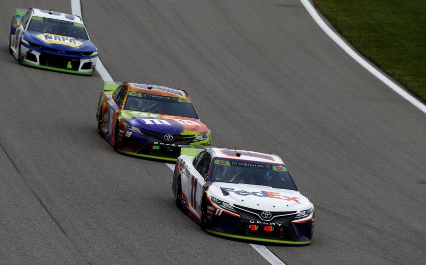 KANSAS CITY, KANSAS - OCTOBER 20: Denny Hamlin, driver of the #11 FedEx Office Toyota, leads Kyle Busch, driver of the #18 M&M's Halloween Toyota, and Chase Elliott, driver of the #9 NAPA Auto Parts Chevrolet, during the Monster Energy NASCAR Cup Series Hollywood Casino 400 at Kansas Speedway on October 20, 2019 in Kansas City, Kansas. (Photo by Jonathan Ferrey/Getty Images) | Getty Images
