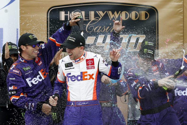 KANSAS CITY, KANSAS - OCTOBER 20: Denny Hamlin, driver of the #11 FedEx Office Toyota, celebrates in Victory Lane after winning the Monster Energy NASCAR Cup Series Hollywood Casino 400 at Kansas Speedway on October 20, 2019 in Kansas City, Kansas. (Photo by Brian Lawdermilk/Getty Images) | Getty Images