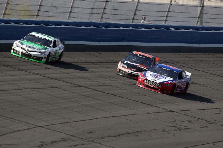 FONTANA, CA - MARCH 24: Kyle Busch, driver of the #18 Interstate Batteries Toyota, takes the lead as Joey Logano, driver of the #22 AAA Southern California Ford, collides with Denny Hamlin, driver of the #11 FedEx Express Toyota, on the the last lap during the NASCAR Sprint Cup Series Auto Club 400 at Auto Club Speedway on March 24, 2013 in Fontana, California. (Photo by Jeff Gross/Getty Images) | Getty Images