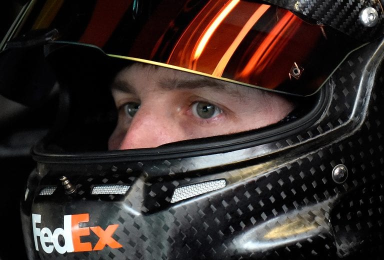 KANSAS CITY, KS - OCTOBER 15:  Denny Hamlin, driver of the #11 FedEx Express Toyota, sits in his car during practice for the NASCAR Sprint Cup Series Hollywood Casino 400 at Kansas Speedway on October 15, 2016 in Kansas City, Kansas.  (Photo by Jason Hanna/Getty Images) | Getty Images