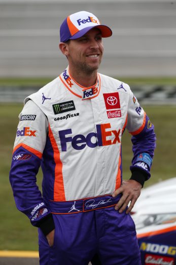 TALLADEGA, ALABAMA - OCTOBER 12: Denny Hamlin, driver of the #11 FedEx Ground Toyota, stands on the grid during qualifying for the Monster Energy NASCAR Cup Series 1000Bulbs.com 500 at Talladega Superspeedway on October 12, 2019 in Talladega, Alabama. (Photo by Brian Lawdermilk/Getty Images) | Getty Images
