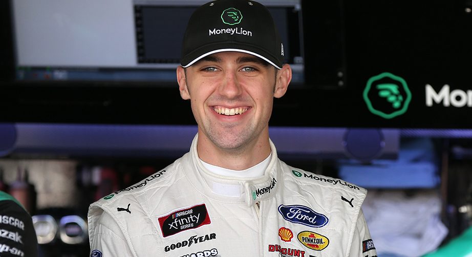DOVER, DELAWARE - OCTOBER 04: Austin Cindric, driver of the #22 MoneyLion Ford, stands by his car during the NASCAR Xfinity Series Use Your Melon Drive Sober 200 at Dover International Speedway on October 04, 2019 in Dover, Delaware. (Photo by Matt Sullivan/Getty Images) | Getty Images