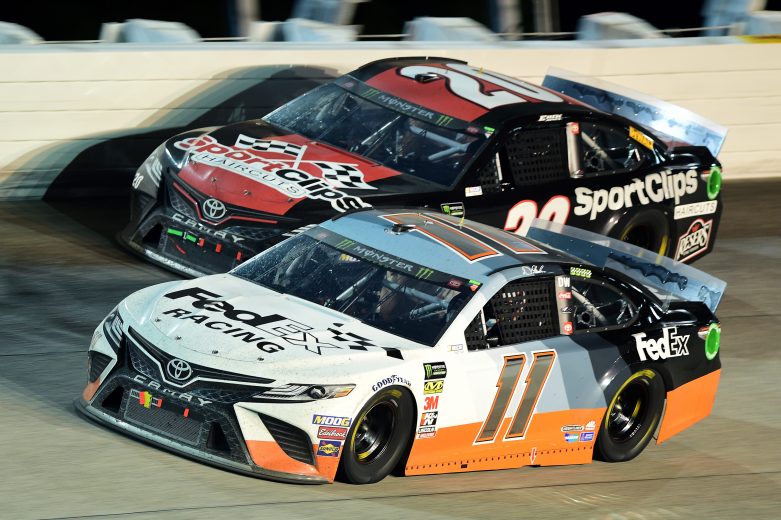 DARLINGTON, SOUTH CAROLINA - SEPTEMBER 02: Denny Hamlin, driver of the #11 FedEx Darlington Throwback Toyota, races Erik Jones, driver of the #20 Sport Clips Throwback Toyota, during the Monster Energy NASCAR Cup Series Bojangles' Southern 500 at Darlington Raceway on September 02, 2019 in Darlington, South Carolina. (Photo by Jared C. Tilton/Getty Images) | Getty Images