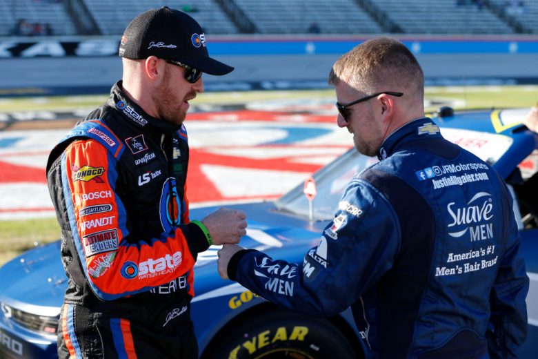FORT WORTH, TEXAS - NOVEMBER 02: Justin Allgaier, driver of the #7 Suave Men Chevrolet, speaks with Jeb Burton, driver of the #8 State Water Heaters Chevrolet, on the grid during the Salute to Veterans Qualifying Day Fueled by The Texas Lottery for the NASCAR Xfinity Series O'Reilly Auto Parts 300 at Texas Motor Speedway on November 02, 2019 in Fort Worth, Texas. (Photo by Brian Lawdermilk/Getty Images) | Getty Images