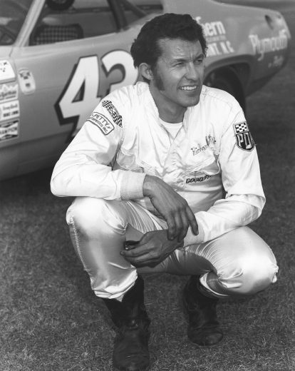 DAYTONA BEACH, FL - FEBRUARY 1971: Richard Petty poses with his Petty Enterprises NASCAR Cup Plymouth that he drove to victory in the Daytona 500 at Daytona International Speedway. This was the last car prior to acquiring STP sponsorship, which for the first time added red to the traditional all Petty Blue paint. (Photo by ISC Images & Archives via Getty Images)