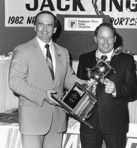 CHARLOTTE, NC - 1982: Jack Ingram (R) accepts his end-of-the-year trophy as national champion in the Budweiser Racing Series (first year of the new Busch Series). Ingram was previously champion for this racing division three times. (Photo by ISC Images & Archives via Getty Images)