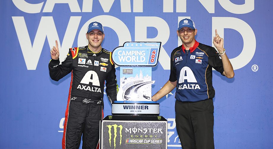 JOLIET, ILLINOIS - JUNE 30: Alex Bowman, driver of the #88 Axalta Chevrolet, and crew chief Greg Ives pose with the trophy after winning the Monster Energy NASCAR Cup Series Camping World 400 at Chicagoland Speedway on June 30, 2019 in Joliet, Illinois. (Photo by Matt Sullivan/Getty Images) | Getty Images