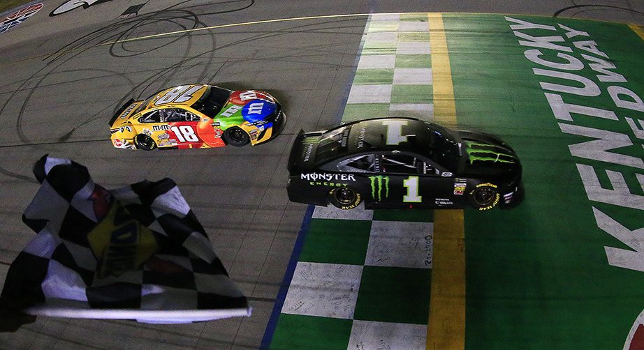 SPARTA, KENTUCKY - JULY 13: Kurt Busch, driver of the #1 Monster Energy Chevrolet, takes the checkered flag ahead of Kyle Busch, driver of the #18 M&M's Toyota Camry Toyota, to win the Monster Energy NASCAR Cup Series Quaker State 400 Presented by Walmart at Kentucky Speedway on July 13, 2019 in Sparta, Kentucky. (Photo by Daniel Shirey/Getty Images)