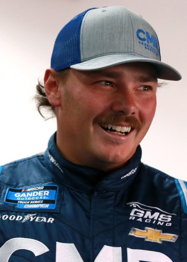 TALLADEGA, ALABAMA - OCTOBER 11: Brett Moffitt, driver of the #24 CMR Construction & Roofing Chevrolet, stands in the garage area during practice for the NASCAR Gander Outdoor Truck Series Sugarlands Shine 250 at Talladega Superspeedway on October 11, 2019 in Talladega, Alabama. (Photo by Sean Gardner/Getty Images) | Getty Images