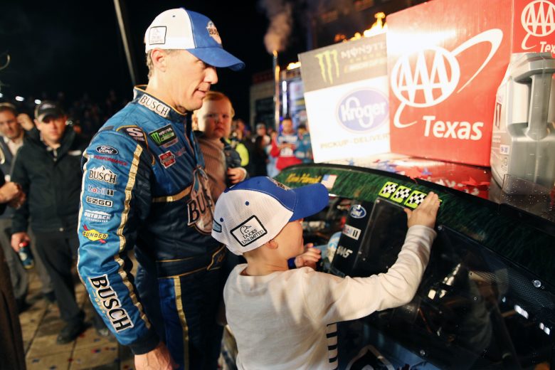 FORT WORTH, TEXAS - NOVEMBER 03: Kevin Harvick, driver of the #4 Busch Beer/Ducks Unlimited Ford, looks on as his son, Keelan, affixes the winner’s decal to his car in Victory Lane after winning the Monster Energy NASCAR Cup Series AAA Texas 500 at Texas Motor Speedway on November 03, 2019 in Fort Worth, Texas. (Photo by Chris Graythen/Getty Images) | Getty Images