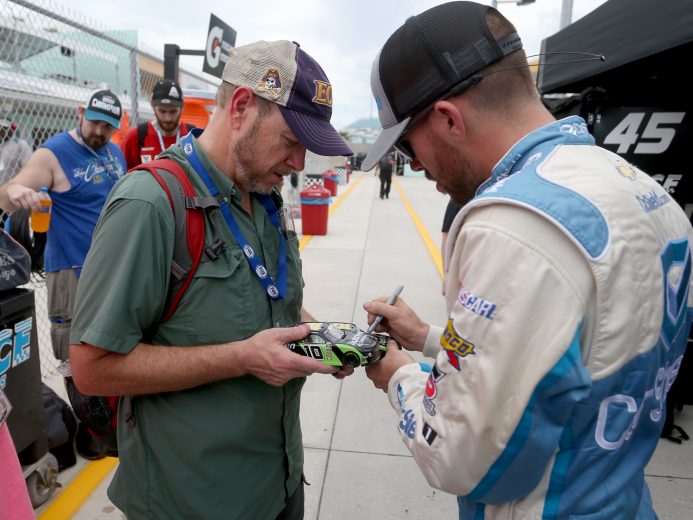 HOMESTEAD, FLORIDA - NOVEMBER 15: Ross Chastain, driver of the #45 CarShield Chevrolet, signs autographs during practice for the NASCAR Gander Outdoors Truck Series Ford EcoBoost200 at Homestead-Miami Speedway on November 15, 2019 in Homestead, Florida. (Photo by Brian Lawdermilk/Getty Images) | Getty Images