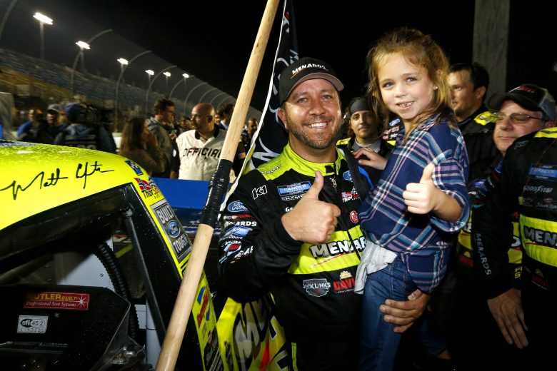HOMESTEAD, FLORIDA - NOVEMBER 15: Matt Crafton, driver of the #88 Jack Links/Menards Ford, poses with his daughter, Elladee, after putting the Champions sticker on his car after winning the NASCAR Gander Outdoors Truck Series Ford Championship at Homestead-Miami Speedway on November 15, 2019 in Homestead, Florida. (Photo by Jonathan Ferrey/Getty Images) | Getty Images