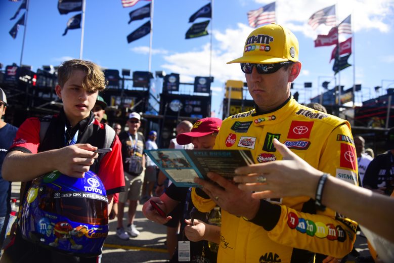 HOMESTEAD, FLORIDA - NOVEMBER 16: Kyle Busch, driver of the #18 M&M's Toyota, signs autographs for fans during practice for the Monster Energy NASCAR Cup Series Ford EcoBoost 400 at Homestead-Miami Speedway on November 16, 2019 in Homestead, Florida. (Photo by Jared C. Tilton/Getty Images) | Getty Images