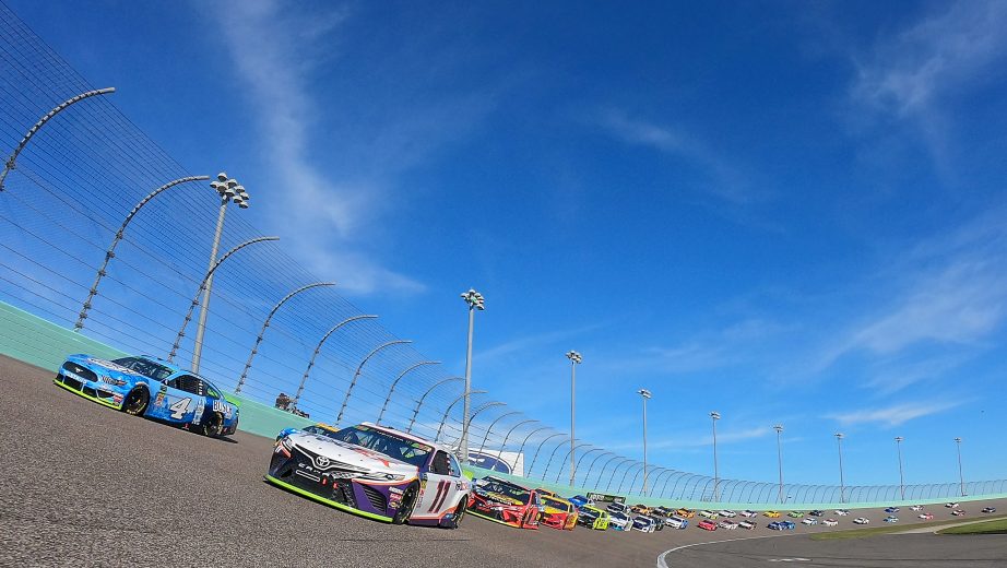 HOMESTEAD, FLORIDA - NOVEMBER 17: Kevin Harvick, driver of the #4 Busch Light Ford, and Denny Hamlin, driver of the #11 FedEx Express Toyota, lead the field at the start of the Monster Energy NASCAR Cup Series Ford EcoBoost 400 at Homestead Speedway on November 17, 2019 in Homestead, Florida. (Photo by Chris Graythen/Getty Images) | Getty Images