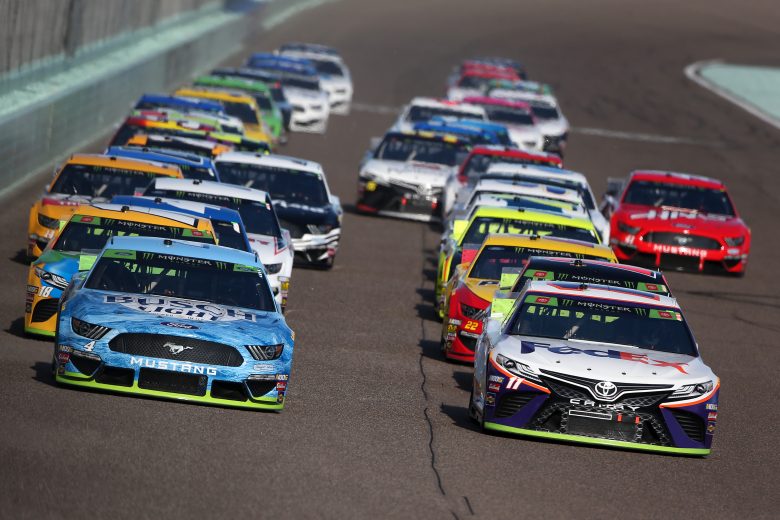 HOMESTEAD, FLORIDA - NOVEMBER 17: Kevin Harvick, driver of the #4 Busch Light Ford, and Denny Hamlin, driver of the #11 FedEx Express Toyota, lead the field at the start of the Monster Energy NASCAR Cup Series Ford EcoBoost 400 at Homestead Speedway on November 17, 2019 in Homestead, Florida. (Photo by Brian Lawdermilk/Getty Images) | Getty Images