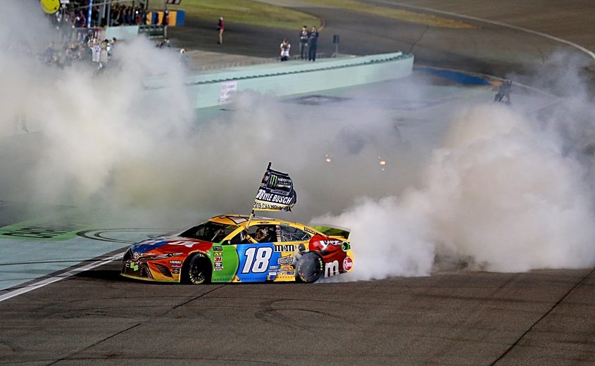 HOMESTEAD, FLORIDA - NOVEMBER 17: Kyle Busch, driver of the #18 M&M's Toyota, celebrates with a burnout after winning the Monster Energy NASCAR Cup Series Cahmpionship and  the Monster Energy NASCAR Cup Series Ford EcoBoost 400 at Homestead Speedway on November 17, 2019 in Homestead, Florida. (Photo by Sean Gardner/Getty Images) | Getty Images