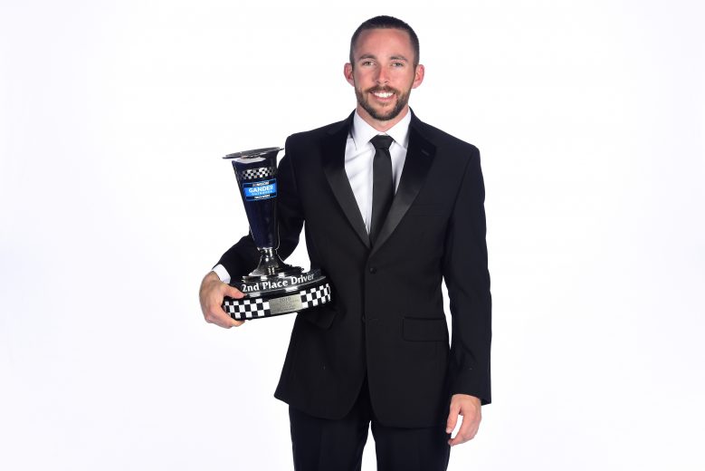 CHARLOTTE, NORTH CAROLINA - NOVEMBER 22: Ross Chastain, NASCAR Gander Outdoors Truck Series driver, poses with the second place trophy during the NASCAR Xfinity Series and NASCAR Gander Outdoors Truck Series Championship Banquet at Charlotte Convention Center on November 22, 2019 in Charlotte, North Carolina. (Photo by Jared C. Tilton/Getty Images) | Getty Images
