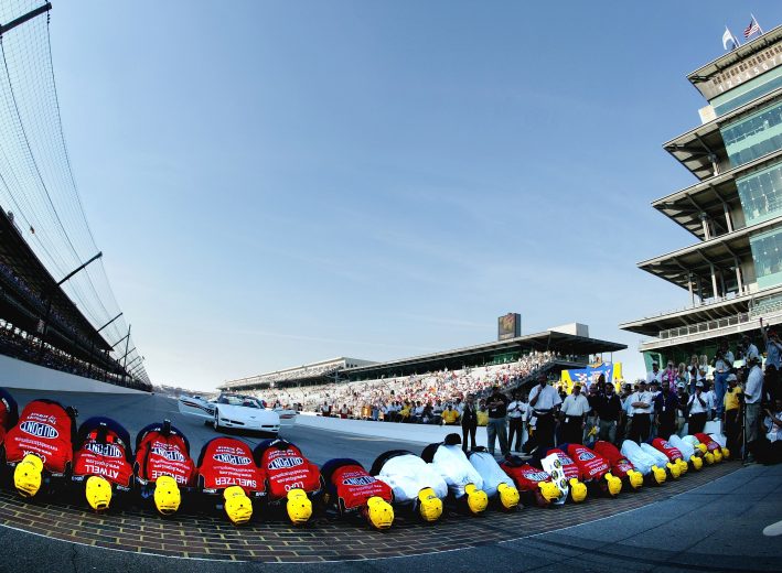 INDIANAPOLIS - AUGUST 8: Jeff Gordon and the #24 DuPont Chevrolet team celebrate winning by kissing the famed yard of bricks at the NASCAR Nextel Cup Series Brickyard 400 on August 8, 2004 at Indianapolis Motor Speedway in Indianapolis, Indiana. (Photo by Darrell Ingham/Getty Images) | Getty Images