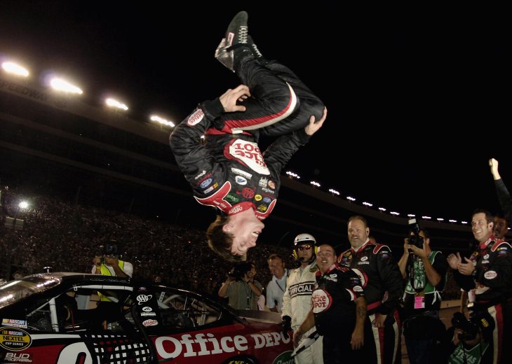 FT. WORTH, TX - NOVEMBER 6: Carl Edwards, driver of the #99 Roush Racing Office Depot Ford, does a back flip off his car after winning the NASCAR Nextel Cup Series Dickies 500 November 6, 2005 at Texas Motor Speedway in Ft. Worth, Texas. (Photo by Rusty Jarrett/Getty Images) | Getty Images