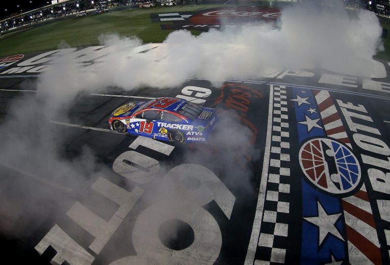 CHARLOTTE, NORTH CAROLINA - MAY 26: Martin Truex Jr., driver of the #19 Bass Pro Shops/TRACKER/USO Toyota, celebrates with a burn out after winning the Monster Energy NASCAR Cup Series Coca-Cola 600 at Charlotte Motor Speedway on May 26, 2019 in Charlotte, North Carolina. (Photo by Brian Lawdermilk/Getty Images) | Getty Images