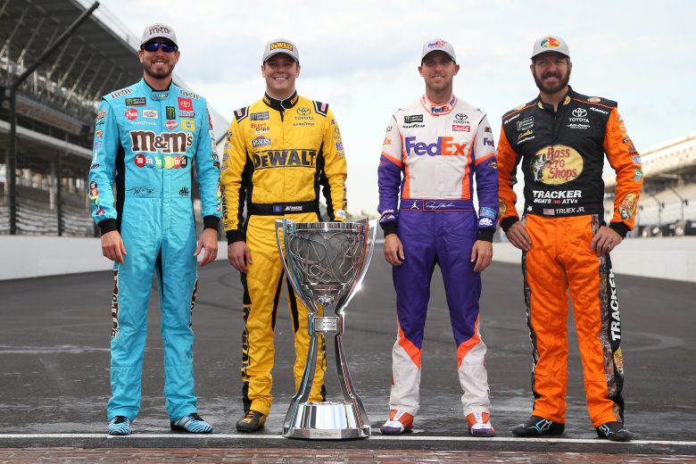 INDIANAPOLIS, INDIANA - SEPTEMBER 08: Kyle Busch, driver of the #18 M&M's Toyota, Erik Jones, driver of the #20 STANLEY Wish For Our Heros Toyota, Denny Hamlin, driver of the #11 FedEx Express Toyota, and Martin Truex Jr, driver of the #19 AOI Toyota, pose for a photo with the Monster Energy NASCAR Cup Series trophy to start the playoffs following the Monster Energy NASCAR Cup Series Big Machine Vodka 400 at the Brickyard at Indianapolis Motor Speedway on September 08, 2019 in Indianapolis, Indiana. (Photo by Brian Lawdermilk/Getty Images) | Getty Images