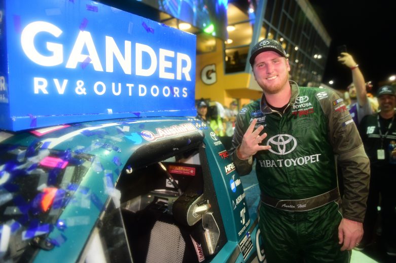 HOMESTEAD, FLORIDA - NOVEMBER 15: Austin Hill, driver of the #16 Chiba Toyopet Toyota, poses with the winner's decal on his car in Victory Lane after winning the NASCAR Gander Outdoors Truck Series Ford EcoBoost 200 at Homestead-Miami Speedway on November 15, 2019 in Homestead, Florida. (Photo by Jared C. Tilton/Getty Images) | Getty Images