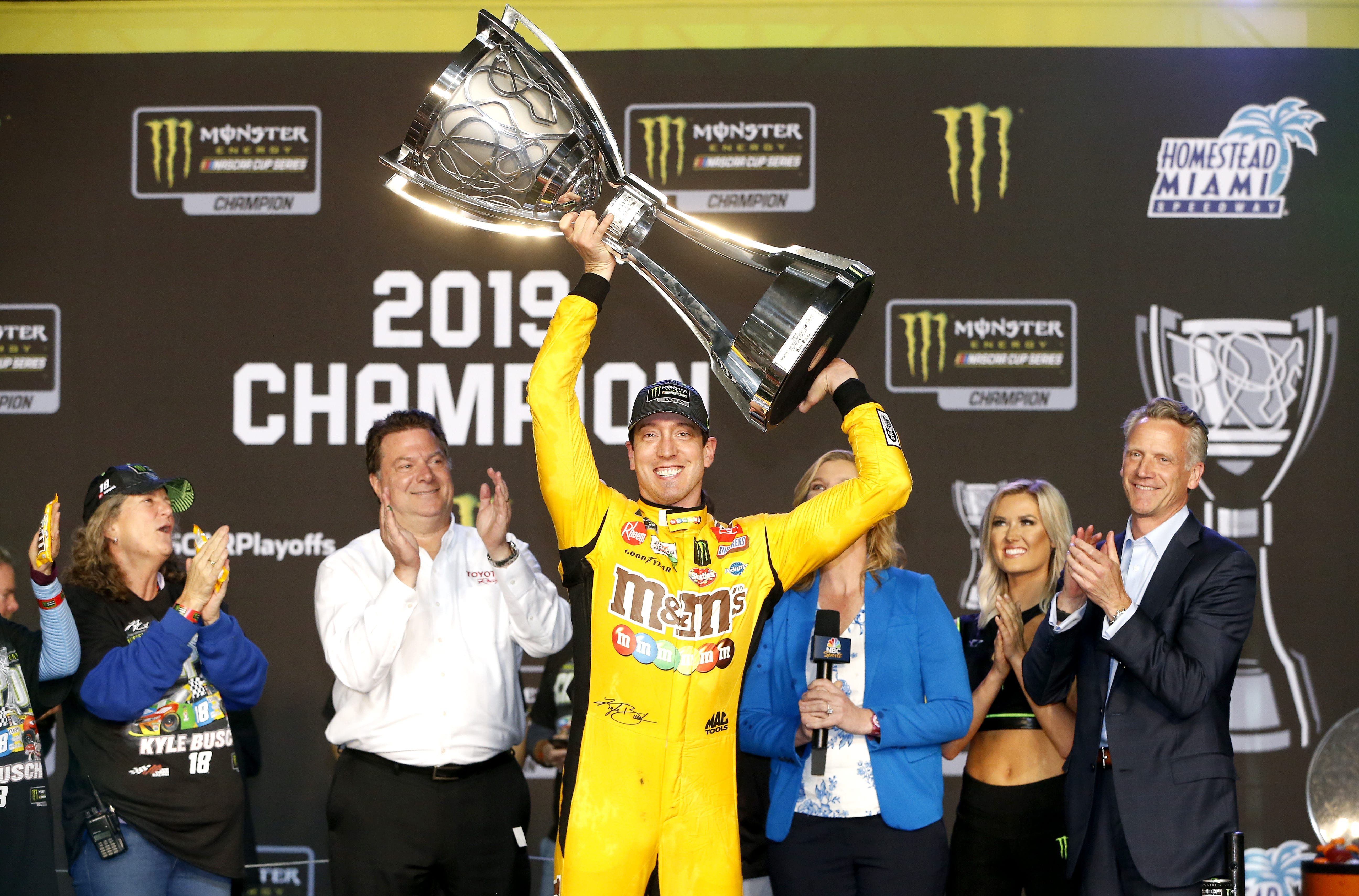 HOMESTEAD, FLORIDA - NOVEMBER 17: Kyle Busch, driver of the #18 M&M's Toyota, hoists the trophy after winning  the Monster Energy NASCAR Cup Series Ford EcoBoost 400 at Homestead Speedway on November 17, 2019 in Homestead, Florida. (Photo by Jonathan Ferrey/Getty Images) | Getty Images