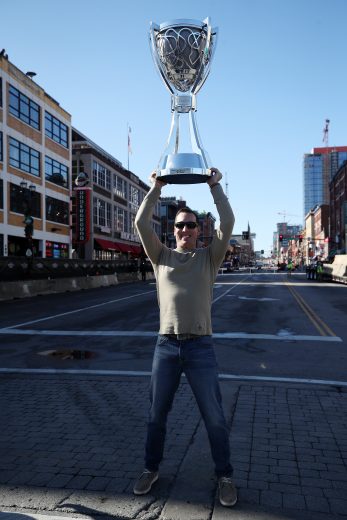 NASHVILLE, TENNESSEE - DECEMBER 04: Monster Energy NASCAR Cup Series Champion Kyle Busch poses for a photo on Broadway with the Championship Trophy on December 04, 2019 in Nashville, Tennessee. (Photo by Chris Graythen/Getty Images) | Getty Images