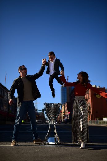 NASHVILLE, TENNESSEE - DECEMBER 04: Monster Energy NASCAR Cup Series Champion Kyle Busch, along with his wife Samantha and son Brexton pose for a photo on Broadway with the Championship Trophy on December 04, 2019 in Nashville, Tennessee. (Photo by Jared C. Tilton/Getty Images) | Getty Images