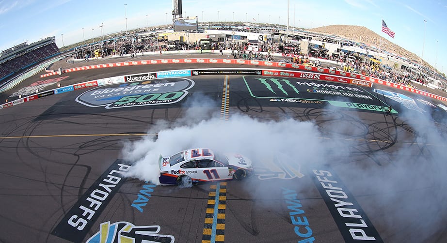 AVONDALE, ARIZONA - NOVEMBER 10: Denny Hamlin, driver of the #11 FedEx Ground Toyota, celebrates with a burnout after winning the Monster Energy NASCAR Cup Series Bluegreen Vacations 500 at ISM Raceway on November 10, 2019 in Avondale, Arizona. (Photo by Matt Sullivan/Getty Images) | Getty Images