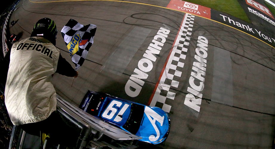 RICHMOND, VA - APRIL 13: Martin Truex Jr, driver of the #19 Auto Owners Insurance Toyota, takes the checkered flag to win the Monster Energy NASCAR Cup Series Toyota Owners 400 at Richmond Raceway on April 13, 2019 in Richmond, Virginia. (Photo by Sean Gardner/Getty Images) | Getty Images