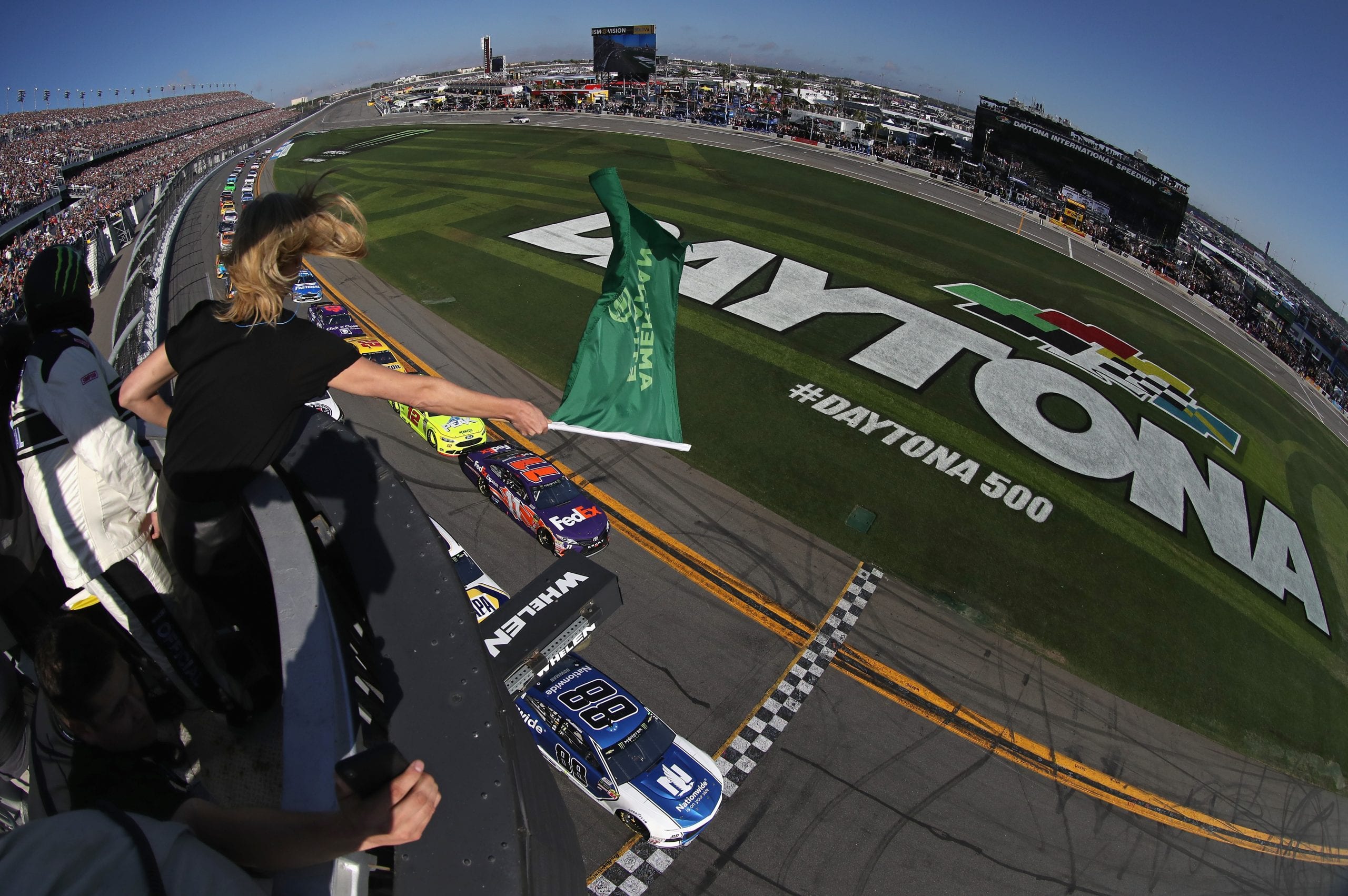 DAYTONA BEACH, FL - FEBRUARY 18:  Actress Charlize Theron waves the green flag to start the Monster Energy NASCAR Cup Series 60th Annual Daytona 500 at Daytona International Speedway on February 18, 2018 in Daytona Beach, Florida.  (Photo by Sean Gardner/Getty Images) | Getty Images