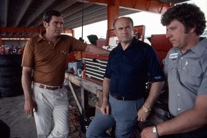 TALLADEGA, AL - 1980: Driver Buddy Baker (L), car owner Harry Ranier (C) and crew chief Waddell Wilson (R) discuss strategy in the garage area at Alabama International Motor Speedway prior to a NASCAR Cup race. (Photo by ISC Images & Archives via Getty Images)