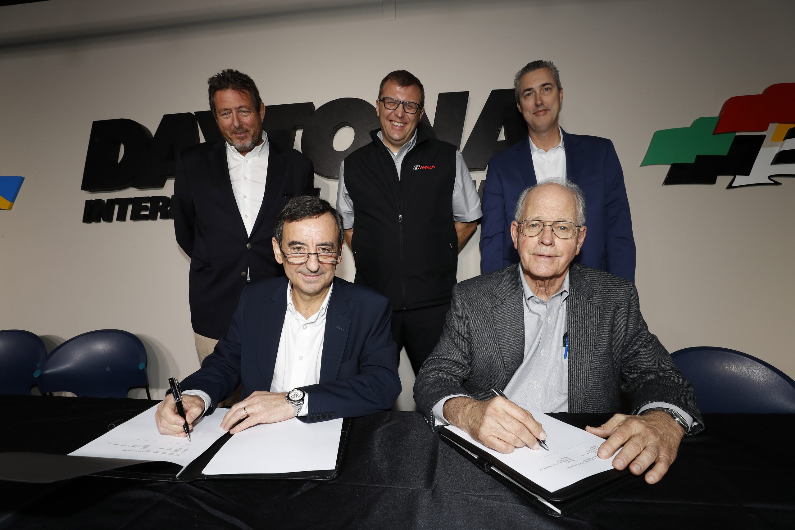 Pierre Fillon, ACO President, and Jim France, IMSA Chairman sign documents introducing the LMDh category which will be shared by WEC and IMSA. They are joined by Gérard Neveu, CEO of the FIA World Endurance Championship, John Doonan, IMSA President, and IMSA CEO Ed Bennett.