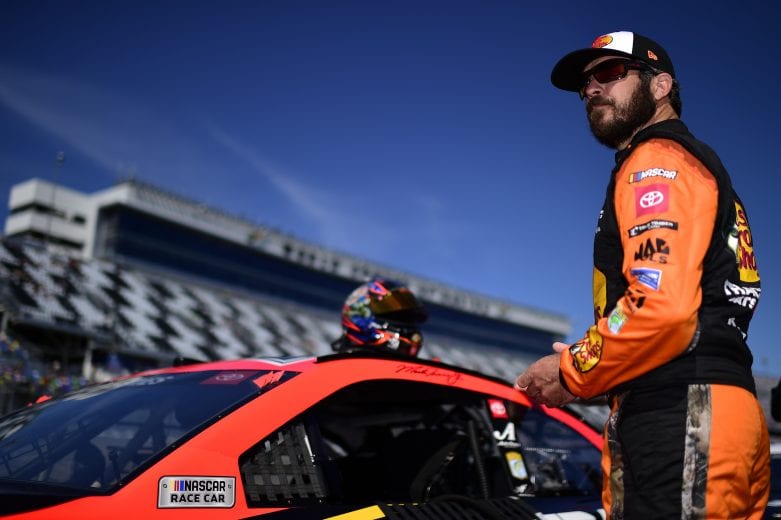 DAYTONA BEACH, FLORIDA - FEBRUARY 09: Martin Truex Jr., driver of the #19 Bass Pros Shops Toyota, stands on the grid during qualifying for the NASCAR Cup Series 62nd Annual Daytona 500 at Daytona International Speedway on February 09, 2020 in Daytona Beach, Florida. (Photo by Jared C. Tilton/Getty Images) | Getty Images
